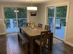 Open kitchen and dining area with pond views, deck access